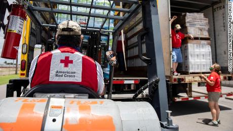 Volunteers for the American Red Cross unload items at warehouse in Mercedes, Texas, on Friday, July 31, 2020.