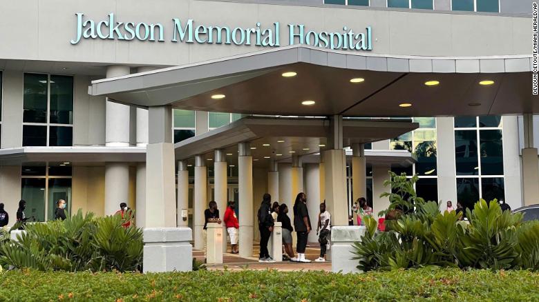 Some of the shooting victims' loved ones wait outside the Ryder Trauma Center at Jackson Memorial Hospital in Miami on Sunday.