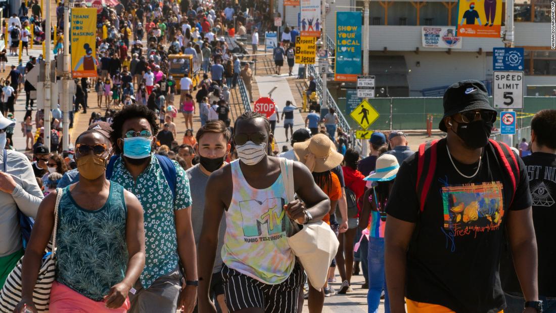 People walk along the Santa Monica Pier in California on Saturday, May 29.