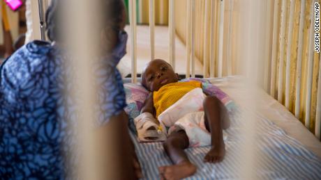 Marie Rose Emile watches over her 6-month-old grandson Jonise as he is treated for malnutrition at the Hospital of Immaculate Conception, in Les Cayes, Haiti, Wednesday, May 26, 2021. 