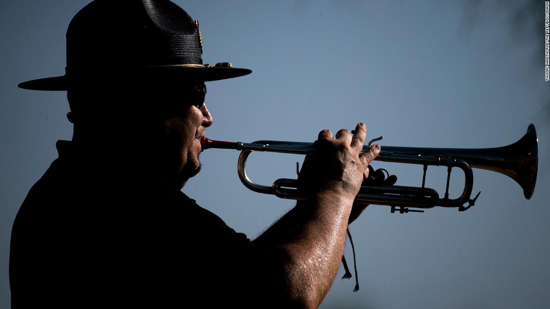 Bugler David Bonczkiewicz plays with the honor guard Monday at the National Memorial Cemetery of Arizona.