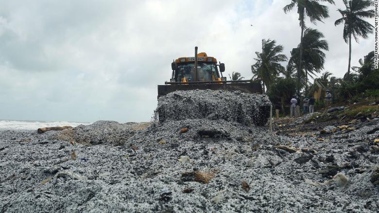 An earthmover removes debris from the X-Press Pearl ship, on a beach at Pamunugama in Negombo, Sri Lanka, on May 28.