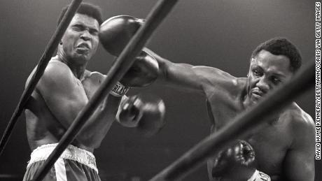 Muhammad Ali takes a hit from Joe Frazier during their heavyweight match which was coined &#39;The Fight of the Century.&#39;