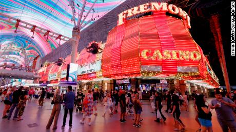 LAS VEGAS, NEVADA - MAY 31:  Visitors walk by the Fremont Hotel &amp; Casino under the Viva Vision canopy attraction at the Fremont Street Experience on May 31, 2021 in Las Vegas, Nevada. Clark County is dropping all pandemic mandates as its COVID-19 mitigation plan expires at midnight on June 1, meaning businesses may operate at 100 percent capacity with no physical distancing restrictions.  (Photo by Ethan Miller/Getty Images)