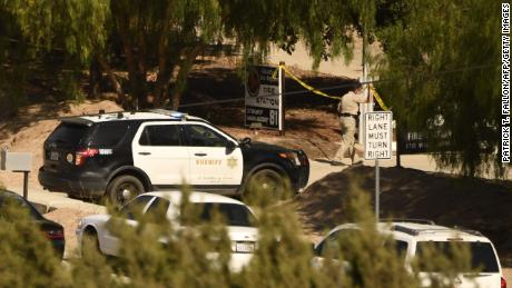 A Los Angeles County Sheriff Department vehicle parks outside the scene of Tuesday&#39;s shooting at a fire station in Agua Dulce, California.