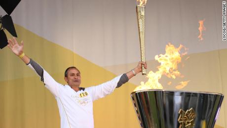 Sherwani lights a cauldron during the Olympic torch relay ahead of the 2012 Games in London.