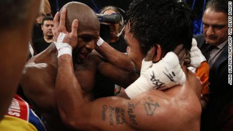 Mayweather hugs Manny Pacquiao after defeating him in their welterweight unification bout.