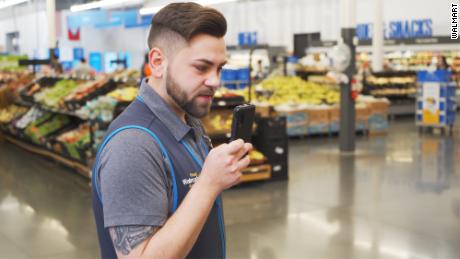 Walmart employee using the new phone.