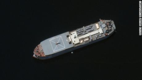 The Iranian ship Makran is seen in this Maxar Technologies satellite image from early May in the Persian Gulf around Larak Island. The boat appears loaded with seven small fast-attack boats on its deck. 