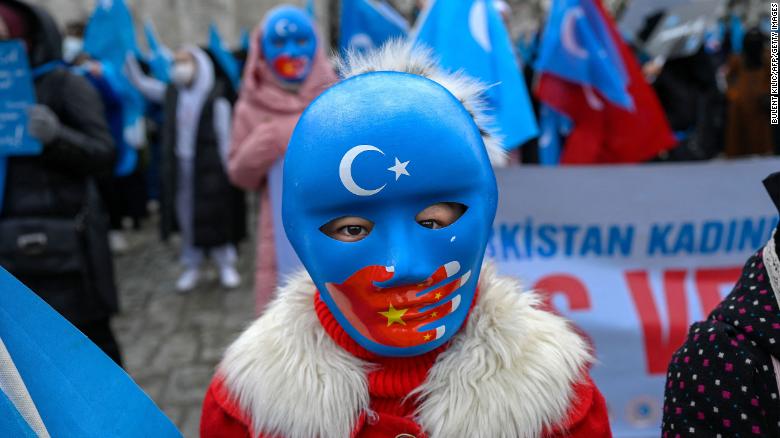 A child from the Uyghur community living in Turkey wears a mask during a protest against the visit of China&#39;s Foreign Minister to Turkey, in Istanbul on March 25, 2021.