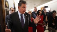 Sen Joe Manchin (D-WV) talks to reporters about his support for a January 6 commission while walking down the hall of the Dirksen Senate Office Building on May 27, 2021 in Washington, DC. 