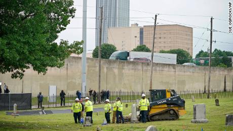 Workers prepare the site where excavation began at Oaklawn Cemetery in a search for victims of the Tulsa Race Massacre believed to be buried in a mass grave, Tuesday, June 1.