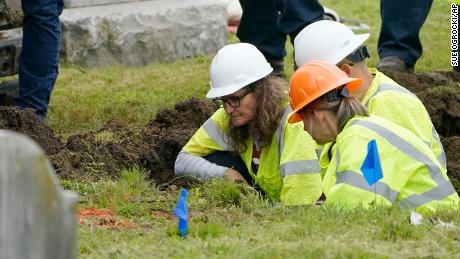 Oklahoma state archaeologist Kary Stackelbeck, left, examines the digging site as excavation begins at Oaklawn Cemetery in Tulsa during a search for victims of the Tulsa Race Massacre believed to be buried in a mass grave on Tuesday, June 1.