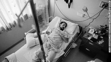 Deotis McMather is pictured asleep in bed at the San Francisco General Hospital&#39;s Ward 5B -- the first AIDS hospital unit in the nation. After being diagnosed with AIDS, he returned to his apartment, where all of his belongings had been thrown out onto the street.