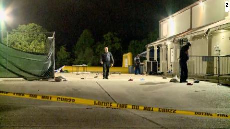 Police look for evidence after an early morning shooting in New Orleans on Sunday.