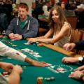Maria Konnikova, center, competes during the first day of the World Series of Poker main event Monday, July 2, 2018, in Las Vegas. (AP Photo/John Locher)