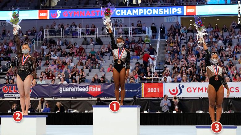 Sunisa Lee, from left, Simone Biles and Jordan Chiles, right, stand on their respective podiums after finishing in the top three following the US Gymnastics Championships, Sunday, June 6, 2021, in Fort Worth, Texas. 