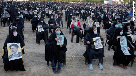 Women supporters of Raisi hold up his posters during a campaign rally in Eslamshahr, outside Tehran, on June 6.