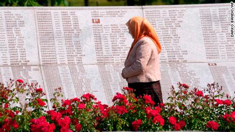 A woman observes the names of victims of the Srebrenica massacre, at the memorial cemetery in Potocari, near Srebrenica, eastern Bosnia, Tuesday, June 8.