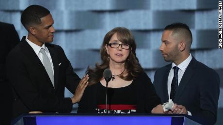 Christine Leinonen, mother of Christopher Andrew Leinonen, is comforted by Brandon Wolf (left) and Jose Arriagada (right), survivors of the Pulse massacre.