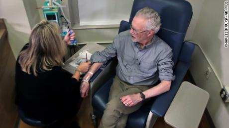 Charles Flagg, who is stricken with Alzheimer's disease, sits for an infusion while participating in a study on the drug Aducanumab at Butler Hospital in Providence, R.I. New results were released on the experimental medicine whose maker claims it can slow the decline of Alzheimer's disease, the most common form of dementia. (AP Photo/Charles Krupa)