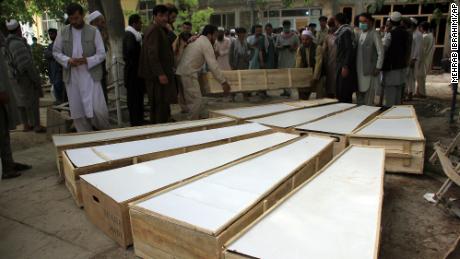 Coffins of victims from the attack in Afghanistan&#39;s Baghlan province are placed on the ground at a hospital on June 9.