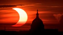 ARLINGTON, VIRGINIA - JUNE 10: In this handout image provided by NASA, a partial solar eclipse is seen as the sun rises behind the Capitol Building on June 10, 2021 in Arlington, Virginia. Northeast states in the U.S. will see a rare eclipsed sunrise, while in other parts of the Northern Hemisphere, this annular eclipse will be seen as a visible thin outer ring of the sun&#39;s disk that is not completely covered by the smaller dark disk of the moon, a so-called &quot;ring of fire&quot;. (Photo by Bill Ingalls/NASA via Getty Images)