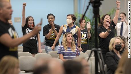 Audience members against the amendment chanted &quot;Allow teachers to teach the truth&quot; during public comments.