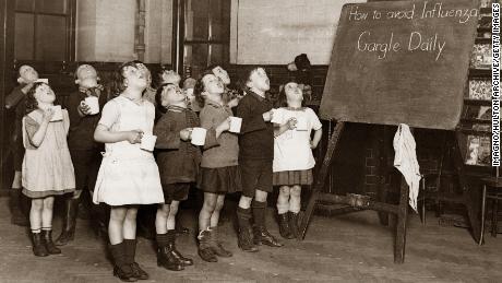 Schoolchildren gargle as a precaution against an influenza epidemic that happened in England sometime around 1935.