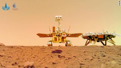 China&#39;s Zhurong rover (center) explores the surface of Mars.
