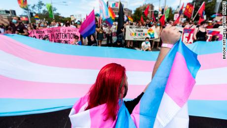 Protesters gather ahead of the Sydney Gay and Lesbian Mardi Gras parade next to a banner with the colors of the trans movement on March 6 in Australia. 