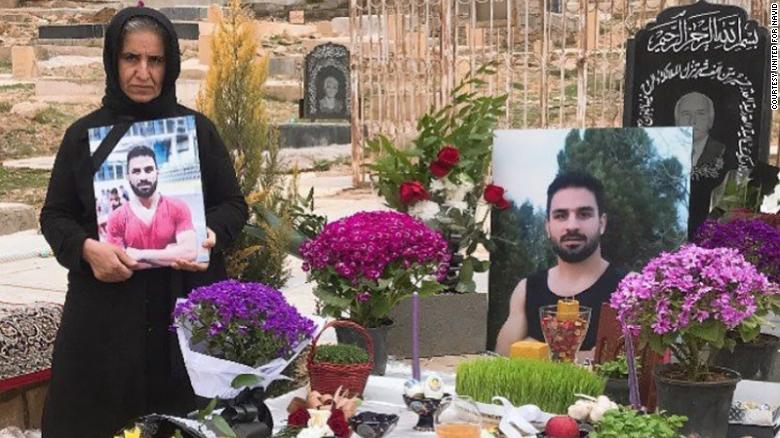 Navid&#39;s mother (left) stands by Navid&#39;s grave in March 2021 in Shiraz, Iran. 