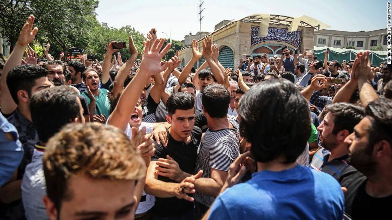 In this June 2018 photo, a group of protesters chant slogans at the main gate of the Old Grand Bazaar, in Tehran, Iran. The case of 27-year-old Navid Afkari has drawn the attention of a social media campaign that portrays him and his brothers as victims targeted over participating in protests against Iran&#39;s Shiite theocracy in 2018. 