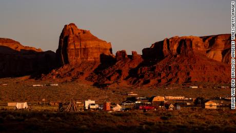 Dawn breaks over homes and sandstone formations near the Monument Valley Navajo Tribal Park on May 24, 2020 in Oljato-Monument Valley, Arizona.