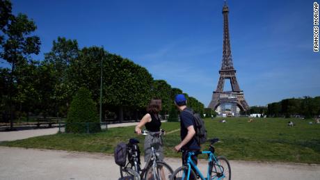 Cyclists take a look at the Eiffel Tower in Paris, Wednesday, June 9, 2021. France is back in business as a tourist destination after opening its borders Wednesday to foreign visitors who are inoculated against the coronavirus with vaccines approved by the European Union&#39;s medicines agency. France&#39;s acceptance of only the Pfizer, Moderna, AstraZeneca and Johnson &amp; Johnson vaccines means that tourism is still barred for would-be visitors from China and other countries that use other vaccines. (AP Photo/Francois Mori)