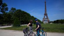 Cyclists take a look at the Eiffel Tower in Paris, Wednesday, June 9, 2021. France is back in business as a tourist destination after opening its borders Wednesday to foreign visitors who are inoculated against the coronavirus with vaccines approved by the European Union&#39;s medicines agency. France&#39;s acceptance of only the Pfizer, Moderna, AstraZeneca and Johnson &amp; Johnson vaccines means that tourism is still barred for would-be visitors from China and other countries that use other vaccines. (AP Photo/Francois Mori)