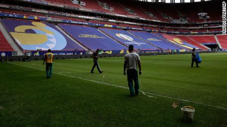 Employees prepare the National Stadium for the Copa America soccer tournament in Brasilia, Brazil, Friday, June 11, 2021. The stadium will host the opening game on June 13. (AP Photo/Eraldo Peres)