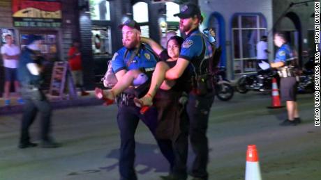A person injured in the shooting is carried to safety.