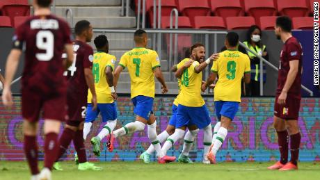 Neymar celebrates with teammates after scoring against Venezuela.
