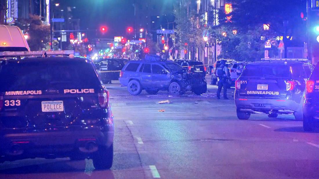 A woman is dead after a car drove through a crowd of protesters in Minneapolis, police say