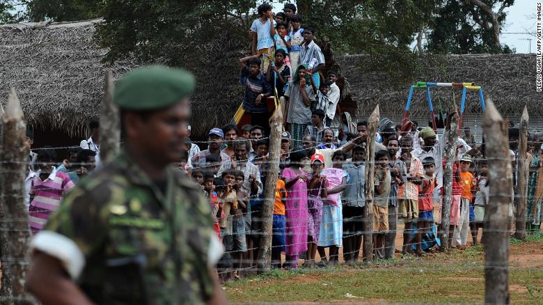Displaced Tamil civilians during a visit by the then French and British Foreign Ministers at Kadirgamh camp in Chettikulam, northern Sri Lanka, April 2009. 