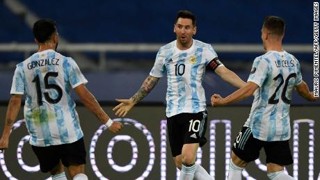Messi celebrates with teammates Nicolas Gonzalez and Giovani Lo Celso after scoring a free-kick against Chile.