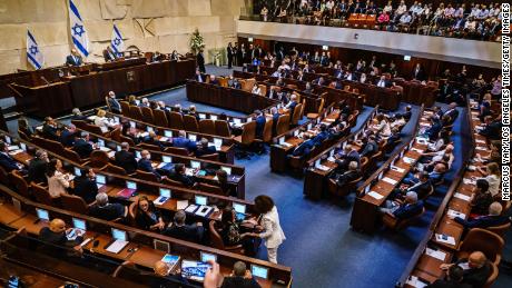 Incoming Prime Minister Naftali Bennett addresses the Knesset, Israel&#39;s parliament, before a vote of confidence was cast confirming the new coalition government on Sunday.