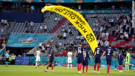 A protester parachuted onto the pitch before the Euro 2020 game between France and Germany.