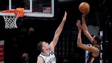 Bucks center Brook Lopez attempts to defend Durant.