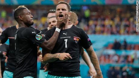 Austria&#39;s Marko Arnautovic, right, celebrates after scoring his side&#39;s third goal during the Euro 2020 match against Northern Macedonia.