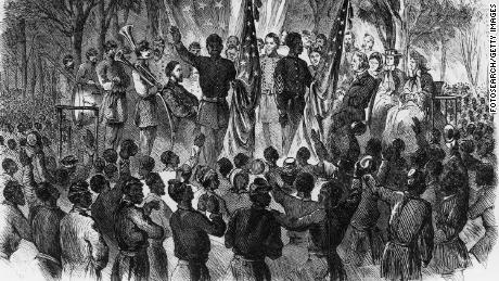 Engraving of large group of black people being addressed by group of white and black soldiers holding the American Flag circa 1863, Caption &#39;Emancipation Day in South Carolina&#39; from Frank Leslie&#39;s Illustrated Newspaper. (Photo by Fotosearch/Getty Images).