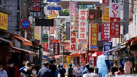 Residents walk in Seoul&#39;s Chinatown neighborhood on June 16.
