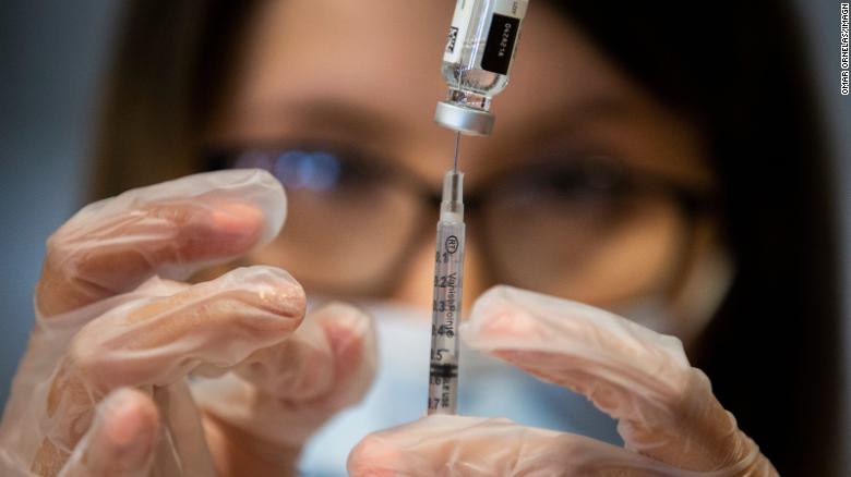 Pharmacist Anais Martinez prepares a Covid-19 vaccine to be administered April 9, 2021, at Holy Spirit Catholic Church in Horizon City, Texas.