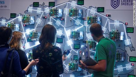 People look at the visualisation during the Locked Shields, cyber defence exercise organized by the NATO Cooperative Cyber Defence Centre of Exellence in Tallinn.